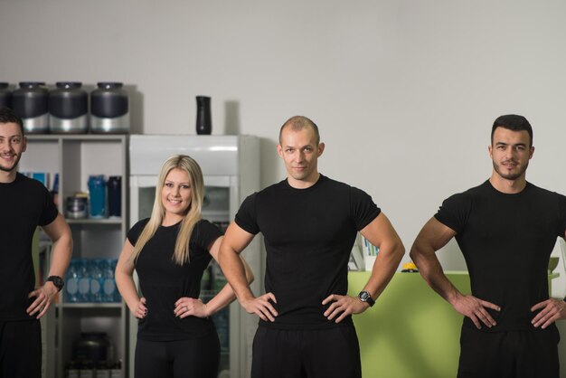 Portrait of Beautiful Sports People Hlooking at Camera in a Gym