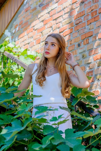 Portrait of beautiful stylish girl walking down the street.