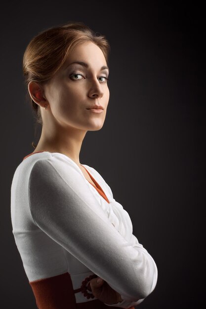 Portrait of the beautiful, sure girl. on a dark background in studio