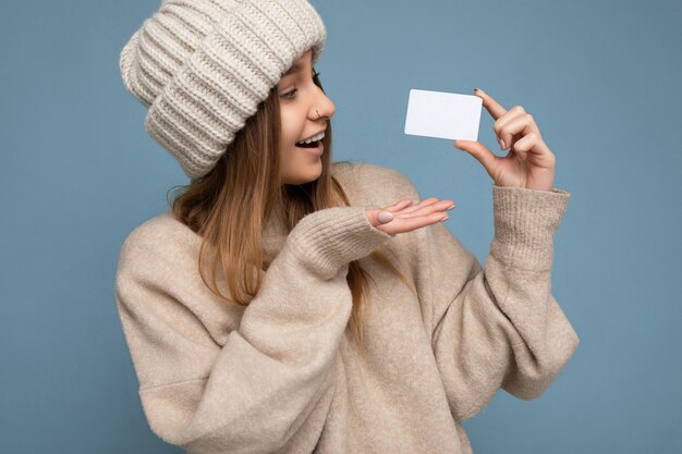 Portrait beautiful surprised happy smiling young dark blonde female person wearing beige sweater