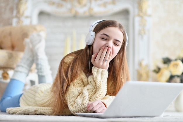 Portrait of beautiful teen girl lying on floor