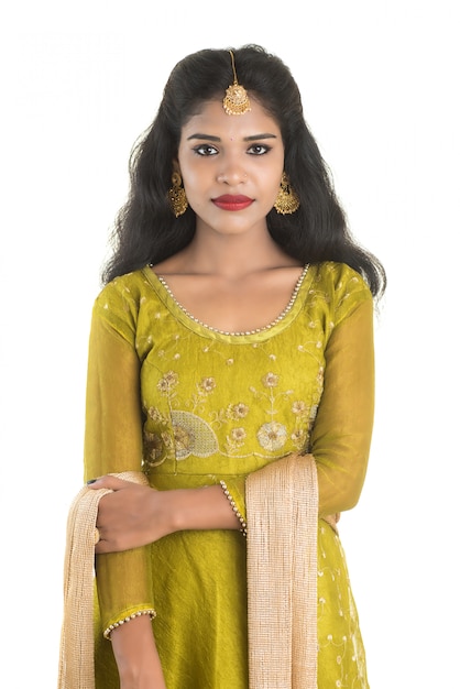 Portrait of beautiful traditional Indian girl posing on white space.