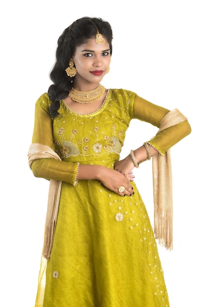 Portrait of beautiful traditional Indian woman posing on white.