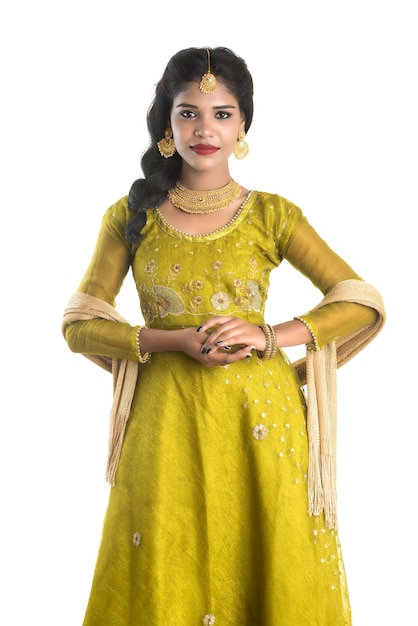 Portrait of beautiful traditional Indian woman posing on white.