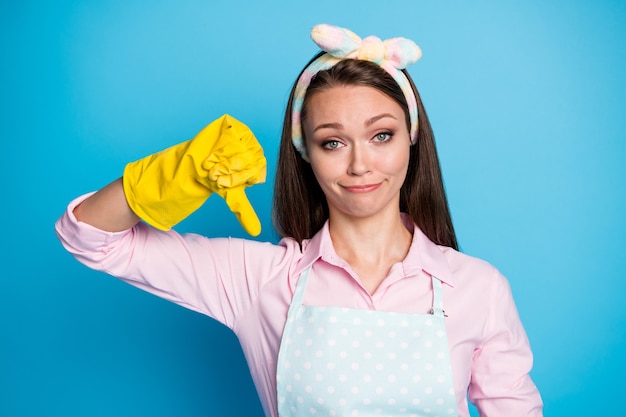 portrait of beautiful upset girl show thumb down symbol