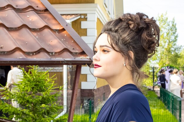 Portrait of a beautiful white girl with a hairstyle in profile Young woman with dark hair