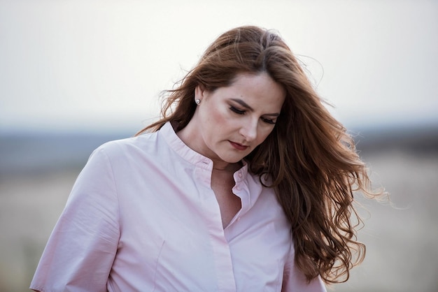 Portrait of beautiful woman against sea