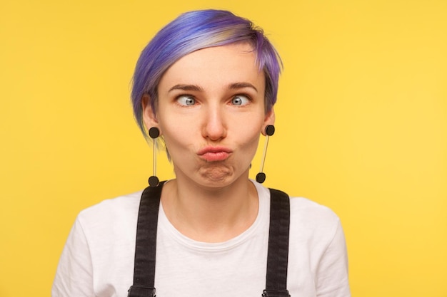 Portrait of beautiful woman against yellow background