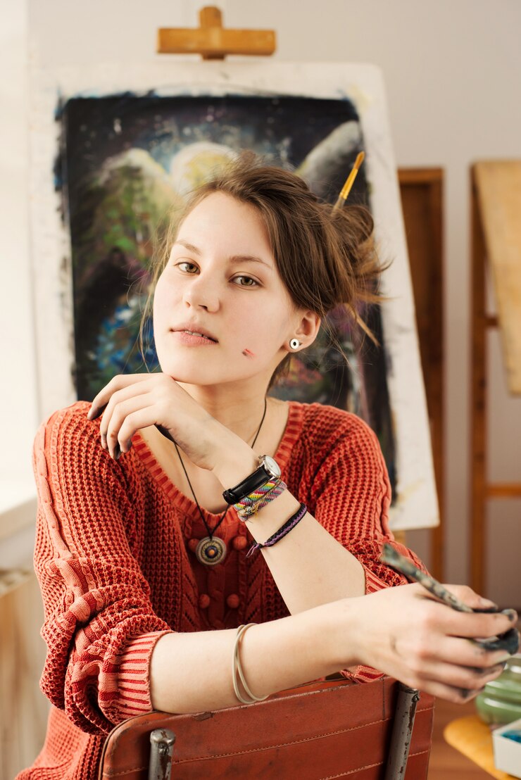 Portrait of beautiful woman artist with positive emotion