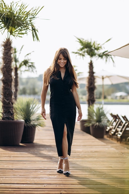 Portrait of beautiful woman in black dress in summer days