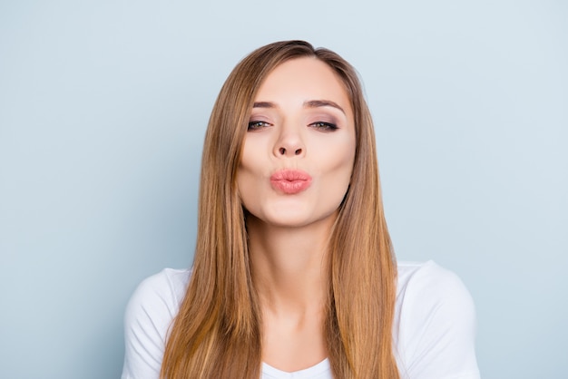 Portrait of beautiful woman blowing kiss