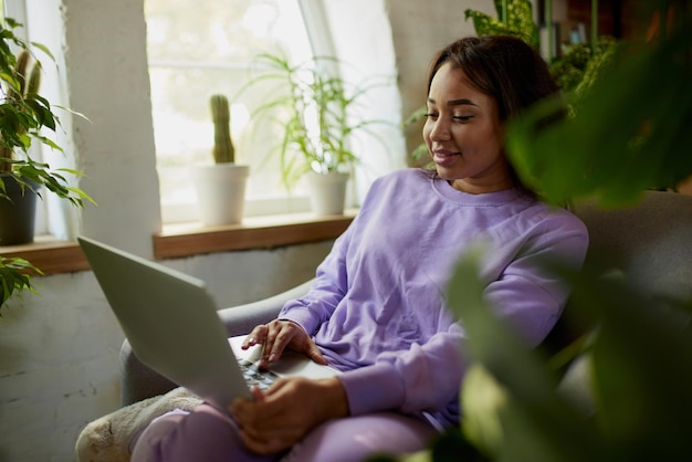 Portrait of beautiful woman doing online shopping on laptop at home comfortable purchasing of goods