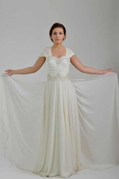 Portrait of a beautiful woman dressed as a bride isolated on white background in studio