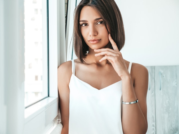 Portrait of beautiful woman dressed in white pajamas. 