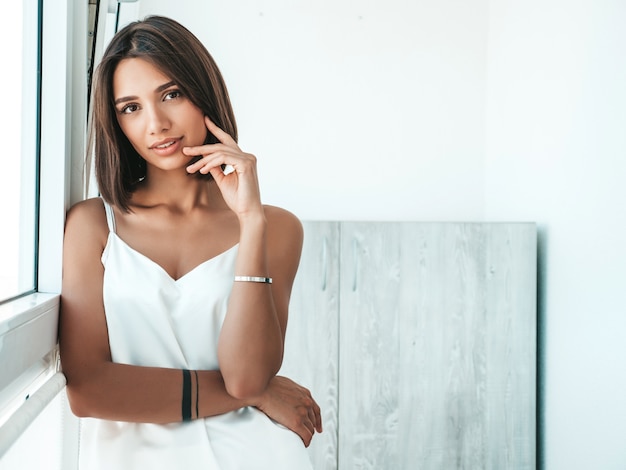 Portrait of beautiful woman dressed in white pajamas