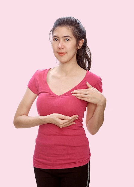 Portrait of beautiful woman gesturing while standing against pink background