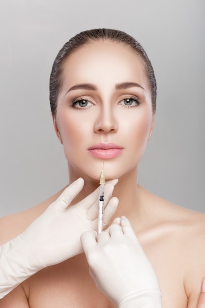 portrait of beautiful woman getting injection. beauty injections and cosmetology