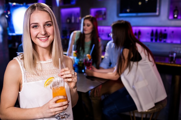 Portrait of beautiful woman having a cocktail