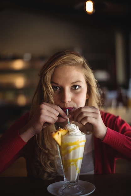 Portrait of beautiful woman having milkshake