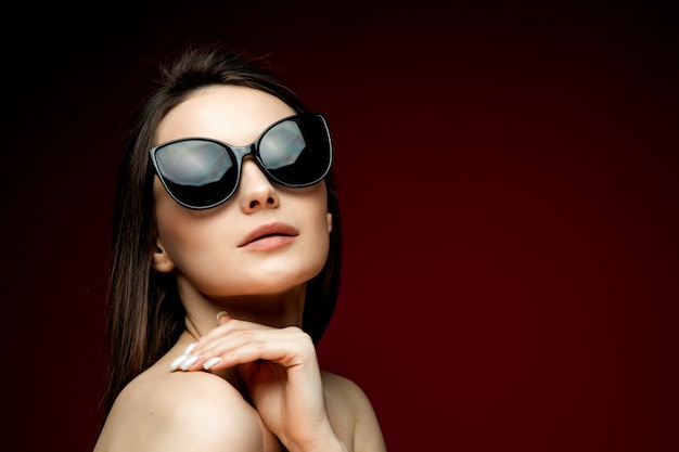 Portrait of beautiful woman in heart-shaped sunglasses