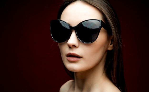 Portrait of beautiful woman in heart-shaped sunglasses
