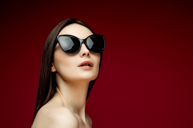 Portrait of beautiful woman in heart-shaped sunglasses