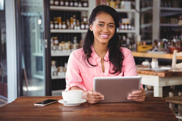 Portrait of beautiful woman holding digital tablet