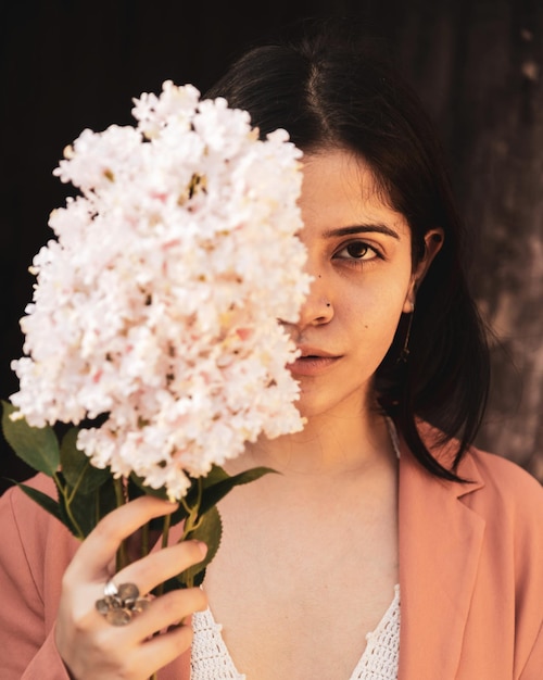portrait of a beautiful woman holding flower bouquet