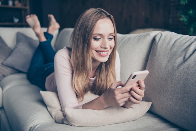 Portrait beautiful woman at home using phone