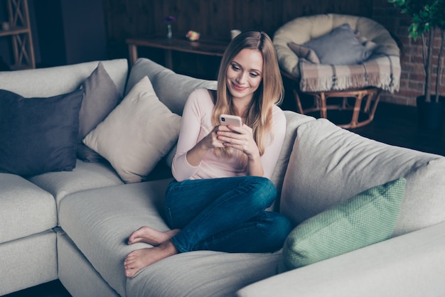 Portrait beautiful woman at home using phone