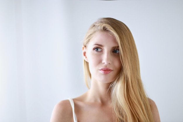 Portrait of beautiful woman isolated on gray background