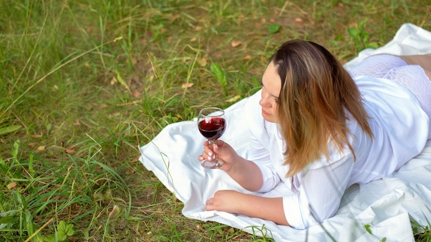 Portrait of beautiful woman laying on grass