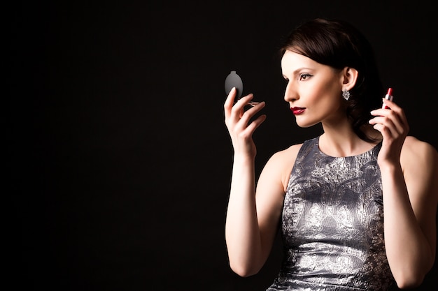 Portrait of a beautiful woman looking in the mirror