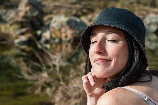 Portrait of beautiful woman on the mountain with closed eyes closeup