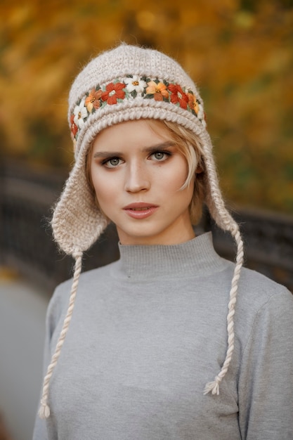 portrait beautiful woman in nature wearing knitted hat
