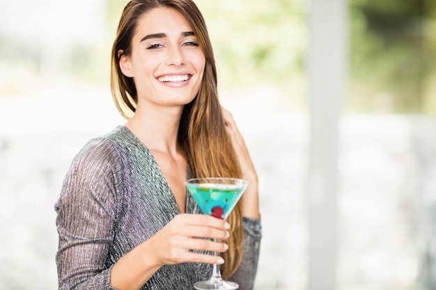 Portrait of beautiful woman smiling and having mocktail