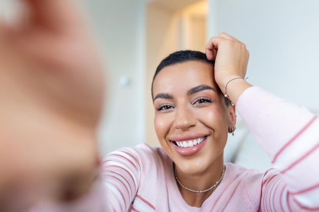 Portrait of a beautiful woman smiling at home African American woman in casual looking at camera with copy space Cheerful mixed race girl relaxing at home with big laugh