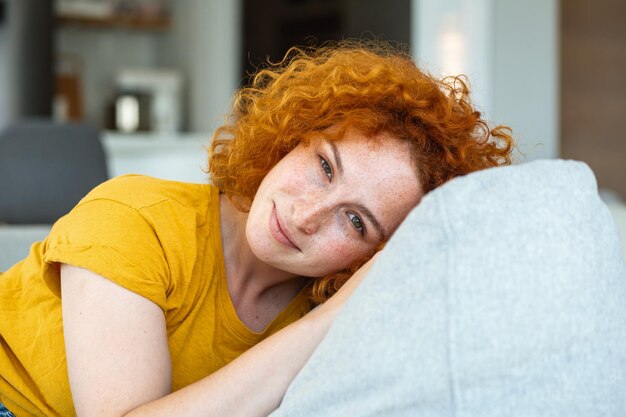 Portrait of a beautiful woman smiling at home woman in casual looking at camera with copy space Cheerful woman relaxing at home with smile