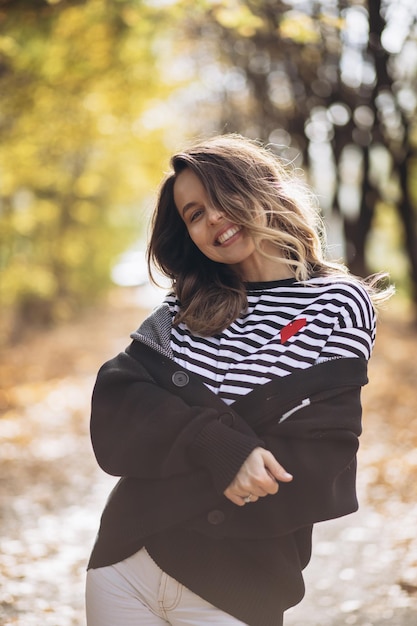 Portrait of beautiful woman smiling and walking in park