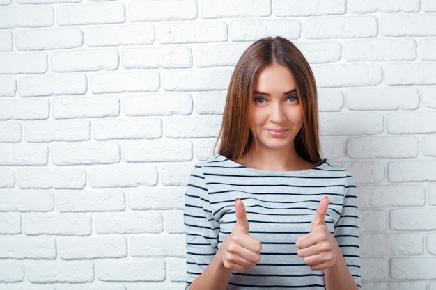 Portrait of beautiful woman smiling while giving ok hand sign