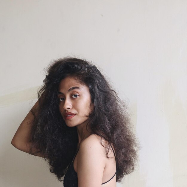 Photo portrait of beautiful woman standing against wall