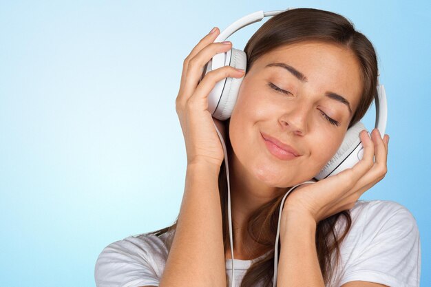 Portrait of a beautiful woman student listening to music