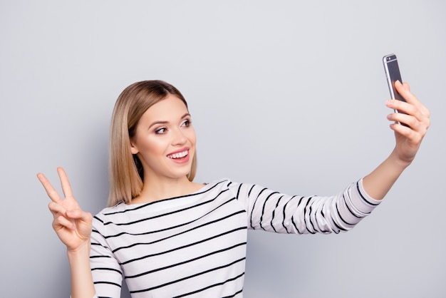 Portrait of beautiful woman taking selfie with smartphone