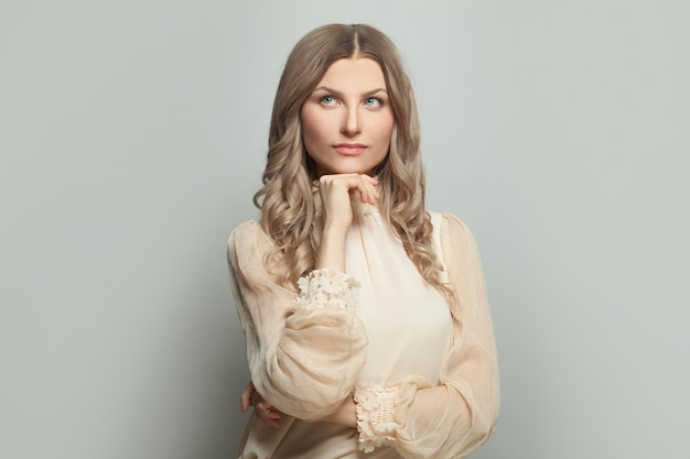 Portrait of beautiful woman thinking on white