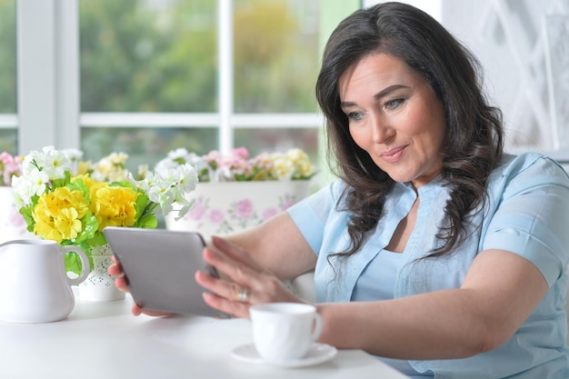 Portrait of beautiful woman using laptop at home