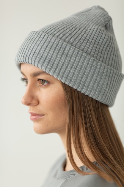 Portrait of beautiful woman in warm clothing and winter hat isolated on white