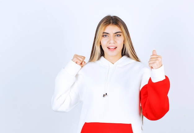 Portrait of a beautiful woman in warm hoodie standing and looking at camera 