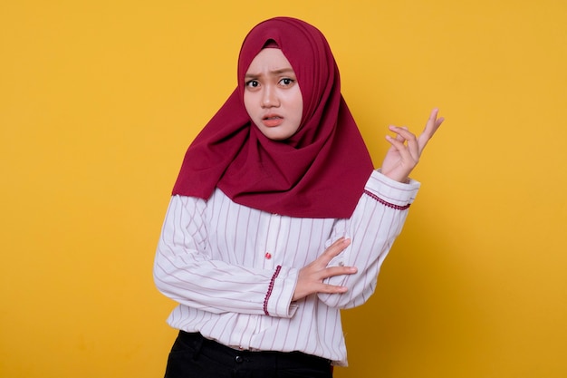 Portrait of beautiful woman wearing hijab pointing left side expression