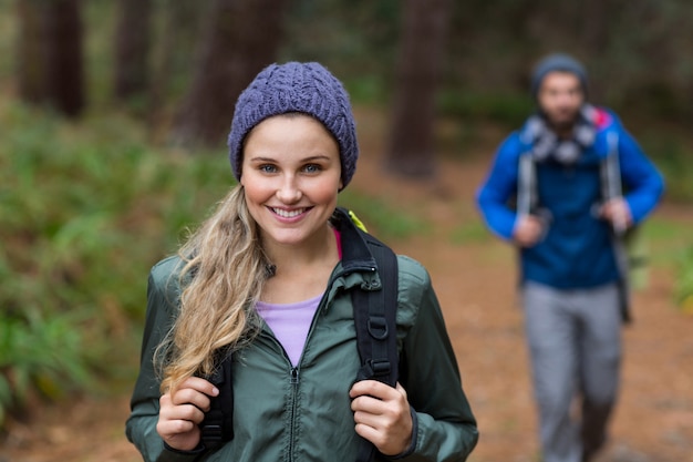 Portrait of beautiful woman while hiking in forest