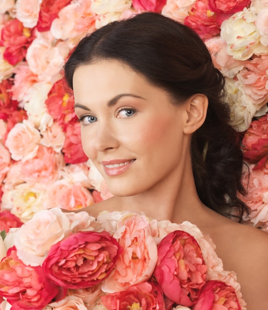 portrait of beautiful woman with background full of roses